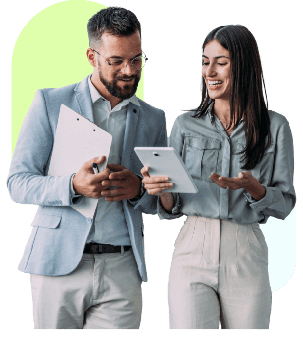 Two professionals discussing with tablet and clipboard.